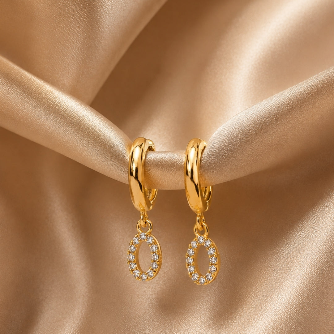 Miayaa Pavé Oval Charm Mini Hoop Earrings gold satin background