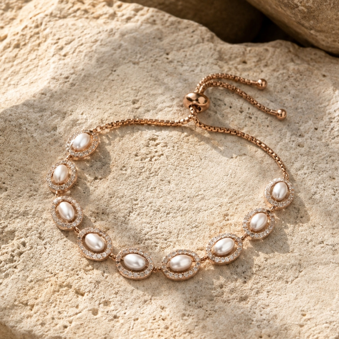 Adjustable pearl and crystal bracelet styled on a warm stone background