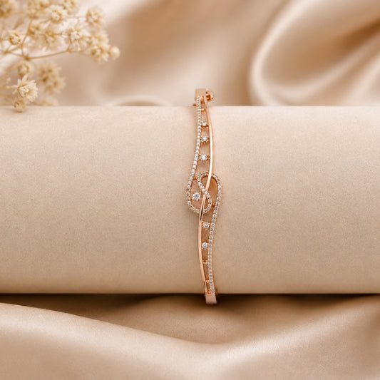 Miayaa Treble Clef Bangle - Rose gold pavé treble clef bangle lifestyle beige background