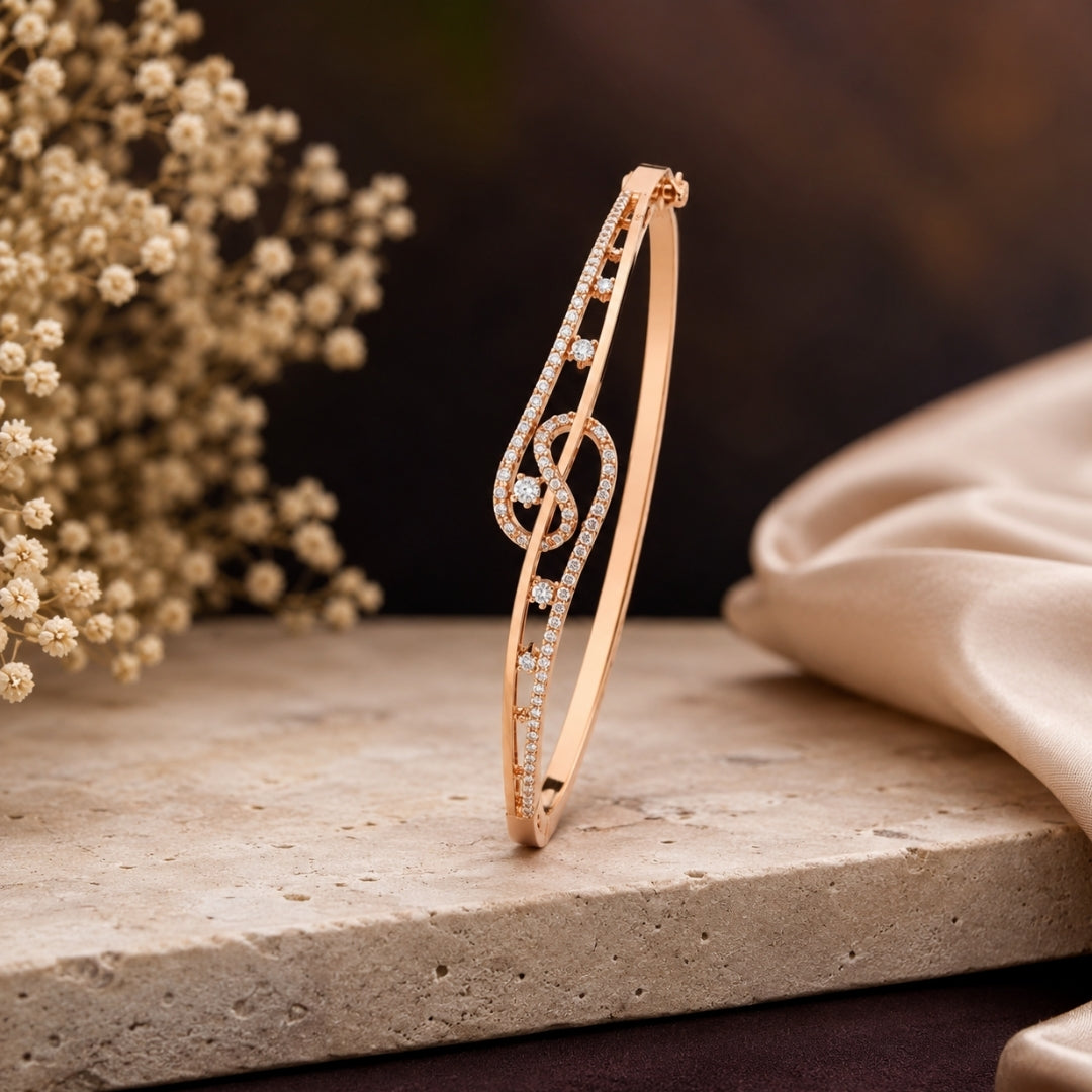 Miayaa Treble Clef Bangle - Rose gold pavé treble clef bangle dark dramatic background